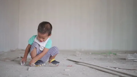 Asian boy playing with stuff at house construction site Video stock 90410000