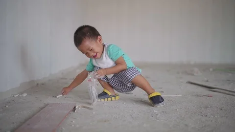 Asian boy playing with stuff at house construction site Stock Footage 90410310