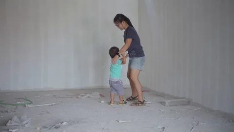 Asian boy playing with stuff at house construction site Stock Footage 90410614