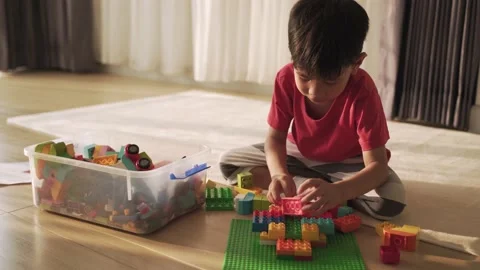 Asian boy playing with toy blocks at home Stock Footage 171783070