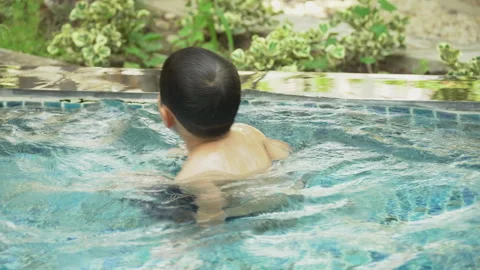 Asian boy  Practice Swimming in the pool Stock Footage 242998685