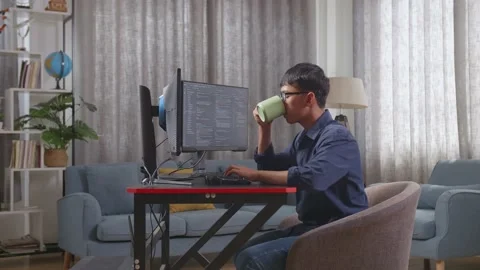 Asian Boy Programmer Drinking Water While Creating Software Engineer Developing Video stock 233460579
