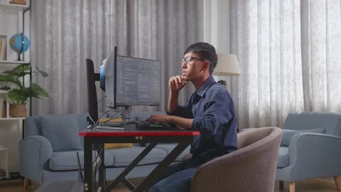 Asian Boy Programmer Thinking About Something And Raising His Index Finger Stock Footage 233460853
