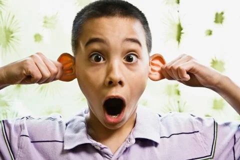 Asian boy pulling on ears Foto stock