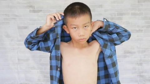 Asian boy is putting on his shirt Stock-Footage 116760853