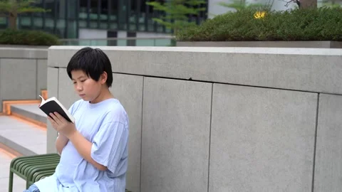 Asian Boy reading and study a book, the bible 4K Stock Footage 139566640