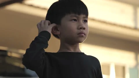 Asian boy scratch his ear. Stock Footage 168853101