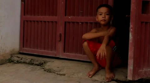 Asian Boy Sitting and Thinking Stock Footage 12169513
