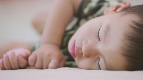 Asian boy sleeping on the bed Stock Footage 86511145