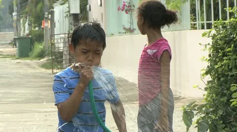 Asian Boy Spraying The Hose During Songkhran Water Festival 스톡 동영상 12437361