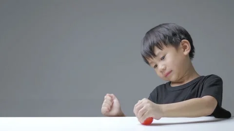 Asian boy squeezes hand therapy ball. Stock Footage 170225289