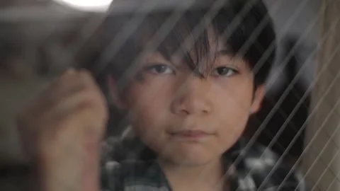 Asian boy staring the camera to show his strong will. Melancholic. Stock Footage 224290360