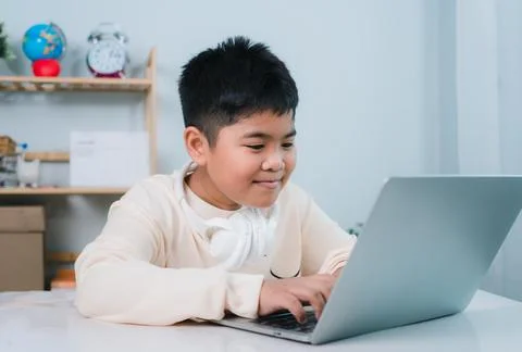 Asian boy student using computer laptop learning. Educational of tech conce.. Stock Photos