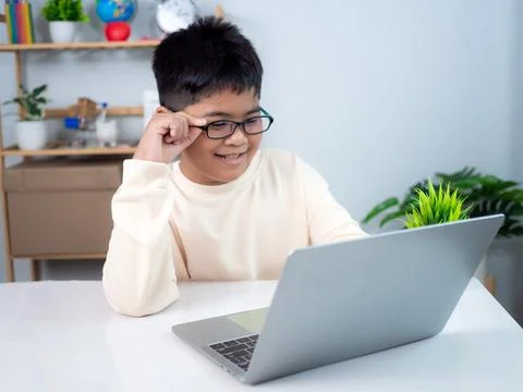 Asian boy student using computer laptop learning. Educational of tech conce.. Stock Photos