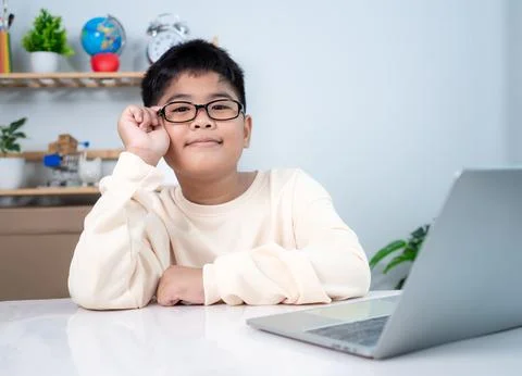 Asian boy student using computer laptop learning. Educational of tech conce.. Stock Photos