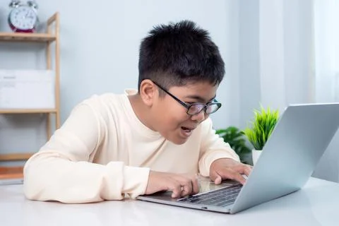 Asian boy student using computer laptop learning. Educational of tech conce.. Stock Photos