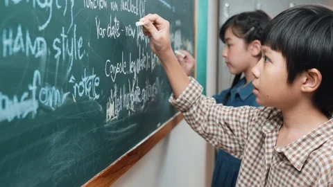 Asian boy study coding engineering prompt while writing at blackboard. Pedagogy. Stock Footage 283886248