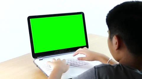 Asian boy typing on a laptop computer. Stock Footage 61868907