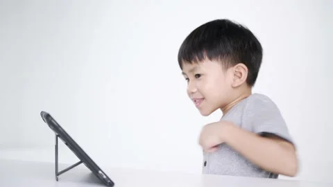 Asian boy using a computer tablet Stock Footage 147337467