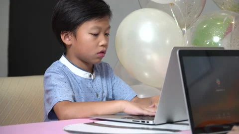 Asian boy using laptop computer in school Stock Footage 145213490