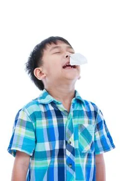 Asian boy using tissue to wipe snot from nose. Isolated on white background. Stock Photos