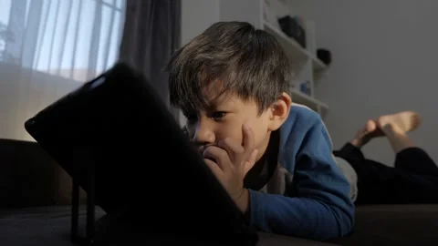 Asian boy watching computer tablet. Stock Footage 154091954