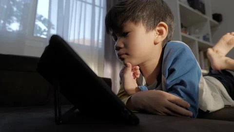 Asian boy watching computer tablet. Stock Footage 171783105