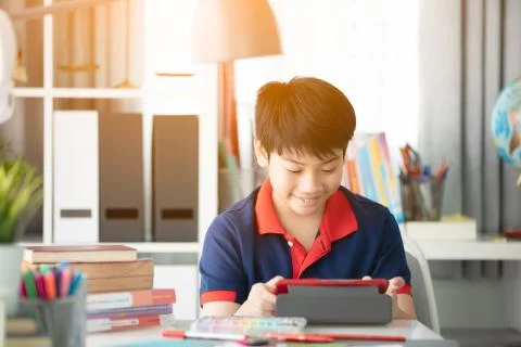 Asian boy watching on tablet computer ,smile face . Stock Photos