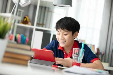 Asian boy watching on tablet computer ,smile face . Stock Photos