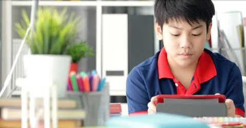 Asian boy watching on tablet computer ,smile face . Stock Photos