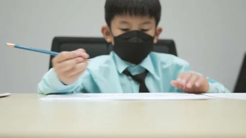 Asian boy writing a test or exam for entering school. Stock Footage 238882283