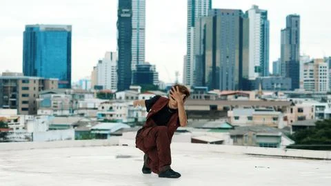 Asian break dancer practice B boy dance with friends at roof top. Hiphop. Stock Photos
