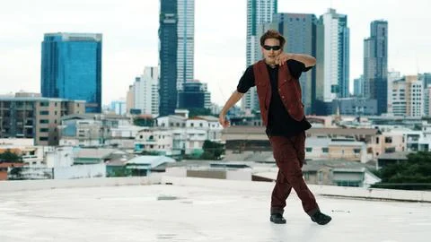 Asian break dancer practice B boy dance with friends at roof top. Hiphop. Stock Photos