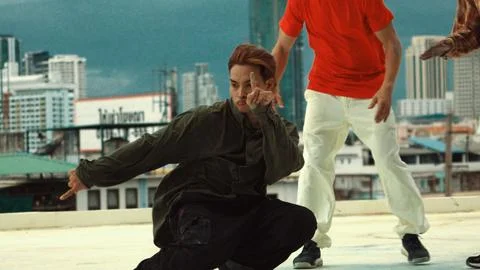 Asian break dancer practice B boy dance with friends at roof top. Hiphop. Stock Photos