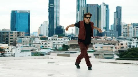 Asian break dancer practice B boy dance with friends at roof top. Hiphop. Stock Photos