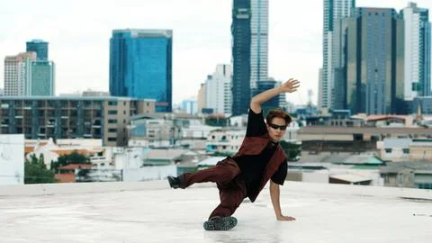 Asian break dancer practice B boy dance with friends at roof top. Hiphop. Stock Photos