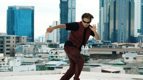 Asian break dancer practice B boy dance with friends at roof top. Hiphop. Stock Photos