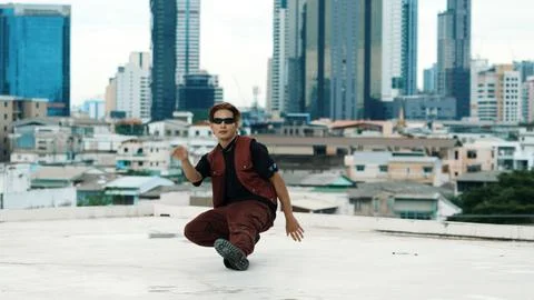 Asian break dancer practice B boy dance with friends at roof top. Hiphop. Stock Photos