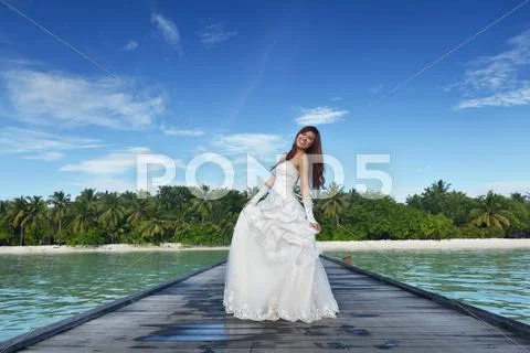 Asian bride on beach Stock Photos