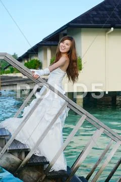 Asian bride on beach Stock Photos