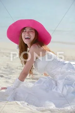 Asian bride on beach Stock Photos
