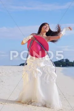 Asian bride on beach Stock Photos
