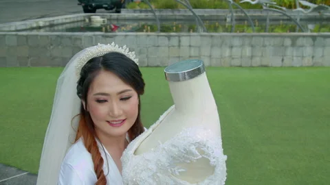 Asian Bride Examining Her Wedding Dress Details Outside Stock Footage 333356437