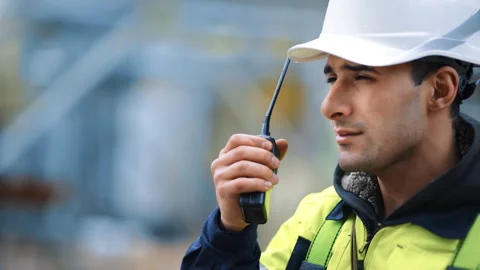 Asian builder constructor in uniform protective helmet use walkie talkie Stock Footage 251660929