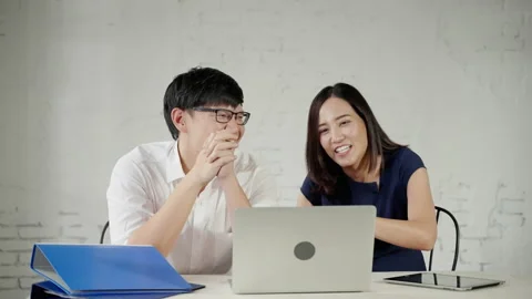 Asian business couple sipping coffee and looking at the top Stock Footage 166313845