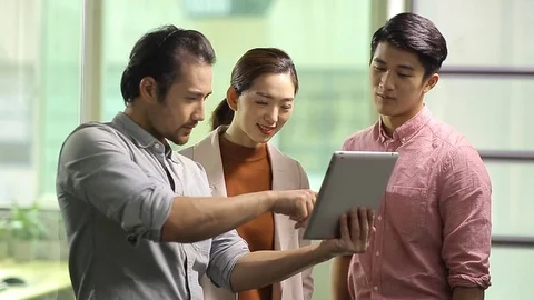 Asian business people talking in office Stock Footage