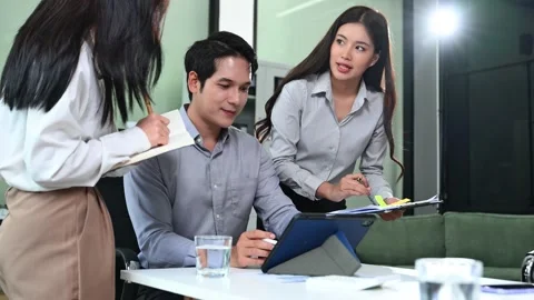 Asian business team analyzing performance data and financial strategy using.. Stock Footage 312442158