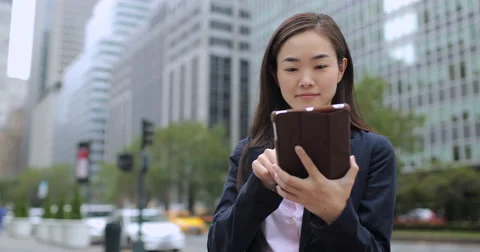 Asian business woman in New York City using tablet computer Stock Footage