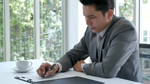Asian businessman checking document upset disappointed wrong report Stock Footage 276676734