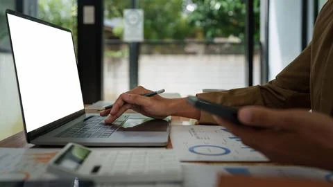 Asian businessman checking information while working with satisfaction on his Stock-Fotos